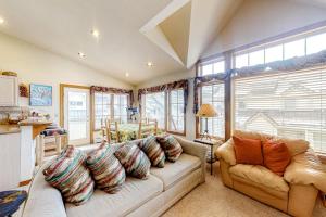 a living room with a couch and some windows at Ski Den #22 in Copper Mountain