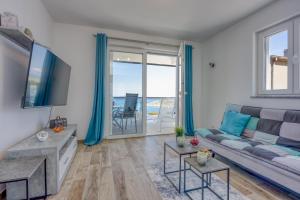 a living room with a couch and a tv at 2Bfree Apartments in Stinica