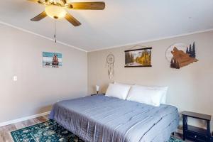 a bedroom with a bed and a ceiling fan at Resting Wildflower in Gunnison