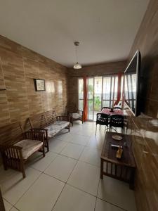 a living room with chairs and a table and a room with tables at Casa completa Janga in Paulista