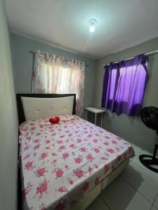 a bedroom with a bed with a red toy on it at Casa completa Janga in Paulista +3 photos