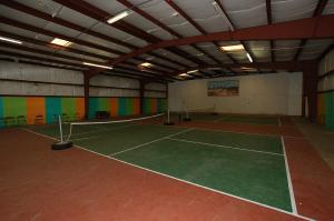 a tennis court in a building with a tennis court at Mount Vernon Camping Resort 16 ft. Yurt 6 in Bow +10 photos