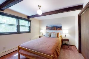 a bedroom with a large bed and a window at Cozy Condo on Chamonix Lane in Vail