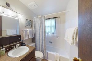 a white bathroom with a sink and a shower at Cozy Condo on Chamonix Lane in Vail +34 photos