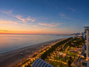 a view of the beach at sunset at Signature Residence Sea View Suites in Marriott Privilege in Batumi +49 photos