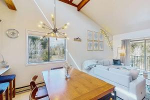 a living room with a white couch and a table at Rustic Relaxation in Winter Park in Winter Park