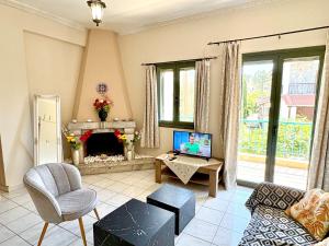 a living room with a couch and a fireplace at Anemeli 2-bedroom apartment, Stoupa in Stoupa