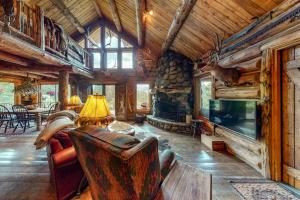 a living room with a large stone fireplace and a couch at Durango Dreams in Durango