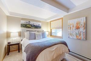 a bedroom with a bed and a window at Torian Plum Plaza 302 in Steamboat Springs +55 photos