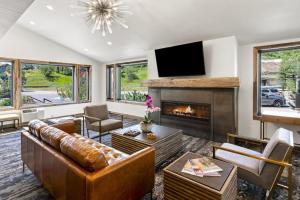 a living room with a couch and a fireplace at Torian Plum Plaza 302 in Steamboat Springs