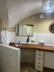 a bathroom counter with a sink and a mirror at Appartamento incantevole Fondo Val di Non in Fondo +17 photos