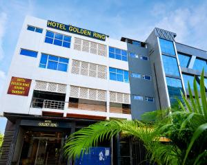 a hotel golden ring building with palm trees in front of it at Hotel Golden Ring in Lucknow +12 photos