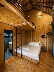 a bedroom with a bunk bed with a ladder at Tom Home Retreat in Mỹ Lại (1)