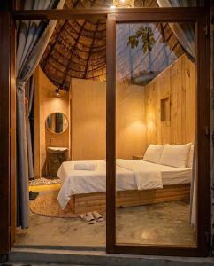 a bedroom with a bed with a large window at Tom Home Retreat in Mỹ Lại (1)