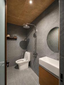 a bathroom with a toilet and a sink and a mirror at Tom Home Retreat in Mỹ Lại (1)