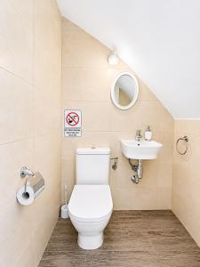 a bathroom with a toilet and a sink at CASA EN EL CENTRO HISTORICO in Nerja +22 photos