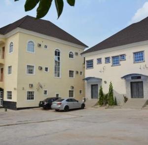 a large building with cars parked in a parking lot at Seadry Suites in Dushepe