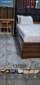 a bedroom with a bed and a desk and a table at Seadry Suites in Dushepe