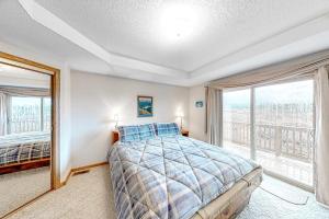 a bedroom with a bed and a large window at Cozy Fraser Cabin in Fraser