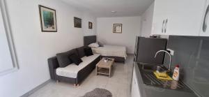 a living room with a couch and a bed at Apartmani Dodig in Neum +35 photos
