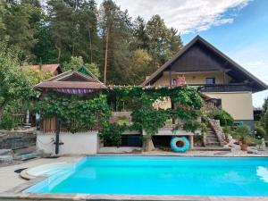 a house with a swimming pool in front of it at Ferienwohnung Jauk in Gleinstätten