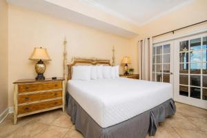 a bedroom with a large bed and a window at The Oasis 2214 formerly Phoenix West II 2214 in Orange Beach
