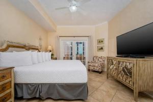 a bedroom with a bed and a flat screen tv at The Oasis 2214 formerly Phoenix West II 2214 in Orange Beach +78 photos