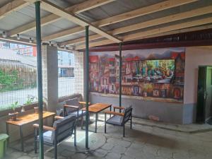 a restaurant with tables and chairs and a painting on the wall at Hotel Mandarin in Ureki