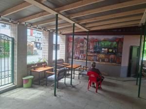 a man sitting in a red chair in a restaurant at Hotel Mandarin in Ureki
