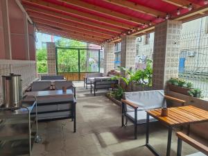 an outdoor patio with tables and chairs and windows at Hotel Mandarin in Ureki