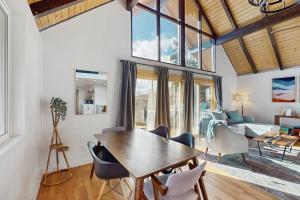 a living room with a wooden table and chairs at The Golden Moose Chalet in Grand Lake