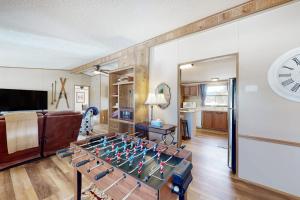 a living room with a foosball table and a clock at Yatahey in South Fork
