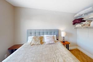 a bedroom with a large bed with two pillows at Mountainside Living in Crested Butte