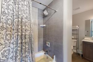 a bathroom with a tub and a shower curtain at Mountainside Living in Crested Butte +41 photos
