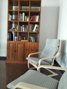 a room with a chair and a book shelf at Hotel Nemo in Misano Adriatico