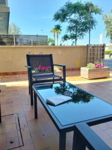a patio with a table and a chair on a patio at Hotel Nemo in Misano Adriatico