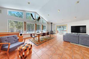 a large living room with a couch and a tv at Lakeside Drive Retreat in Fairplay