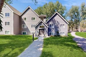 a large house with a driveway and grass at Eagle River's Charmer in Edwards
