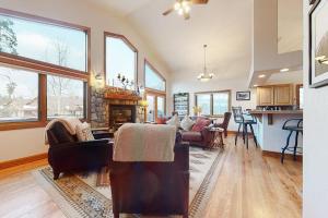 a living room with a couch and a fireplace at Elk Trail Retreat in Winter Park +38 photos