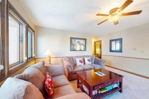 a living room with a couch and a ceiling fan at Basking in Breckenridge Brilliance in Breckenridge
