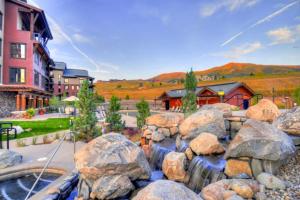 a water feature in the middle of a yard with rocks at First Tracks 4105 in Steamboat Springs