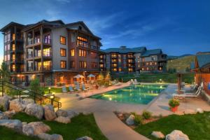 an exterior view of a resort with a swimming pool at First Tracks 4105 in Steamboat Springs