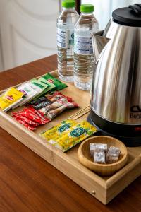 a wooden tray with a tea kettle and some food at Dolphins Otel in Akçakoca