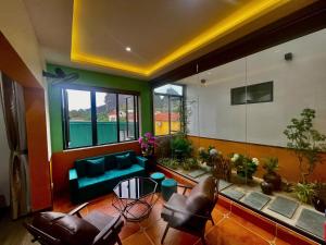a living room with a couch and some plants at Tam Coc Mountain View Homestay in Ninh Binh