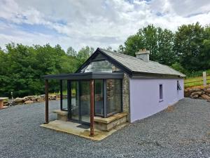 a small shed with a roof and glass at Lakelands Cottage in Nenagh