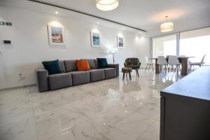a living room with a couch and a table at B6 Dahlet Ta Cenc in Sannat
