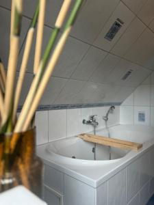 a bathroom with a bath tub with a faucet at Ferienwohnung Blumenthal bei Kiel in Blumenthal