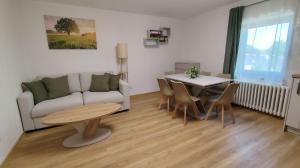 a living room with a couch and a table at Apartmán Kozolupy in Kozolupy