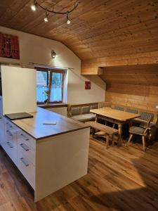 a kitchen and dining room with a table and bench at Ferienwohnungen März in Söchtenau