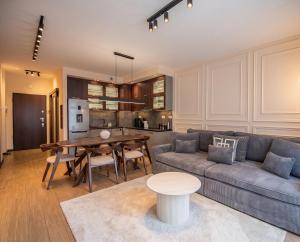a living room with a couch and a table at City Lights Apartments in Krakow